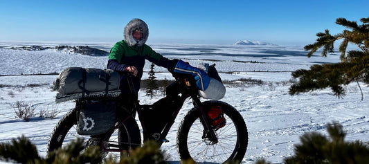 Ana Jager on Iditarod trail standing with loaded Salsa Mukluk fat bike