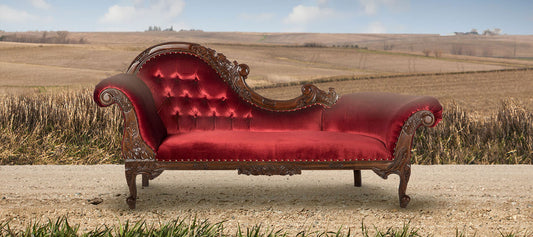 Chaise set on gravel road with rolling farmland behind