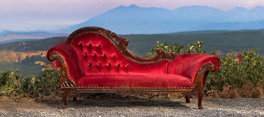 Chaise on side of gravel road overlook with mountains in distance