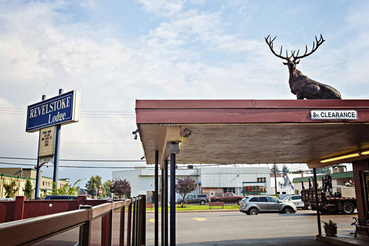 Revelstoke Lodge motel sign and awning over entrance with large brown plastic elk on top