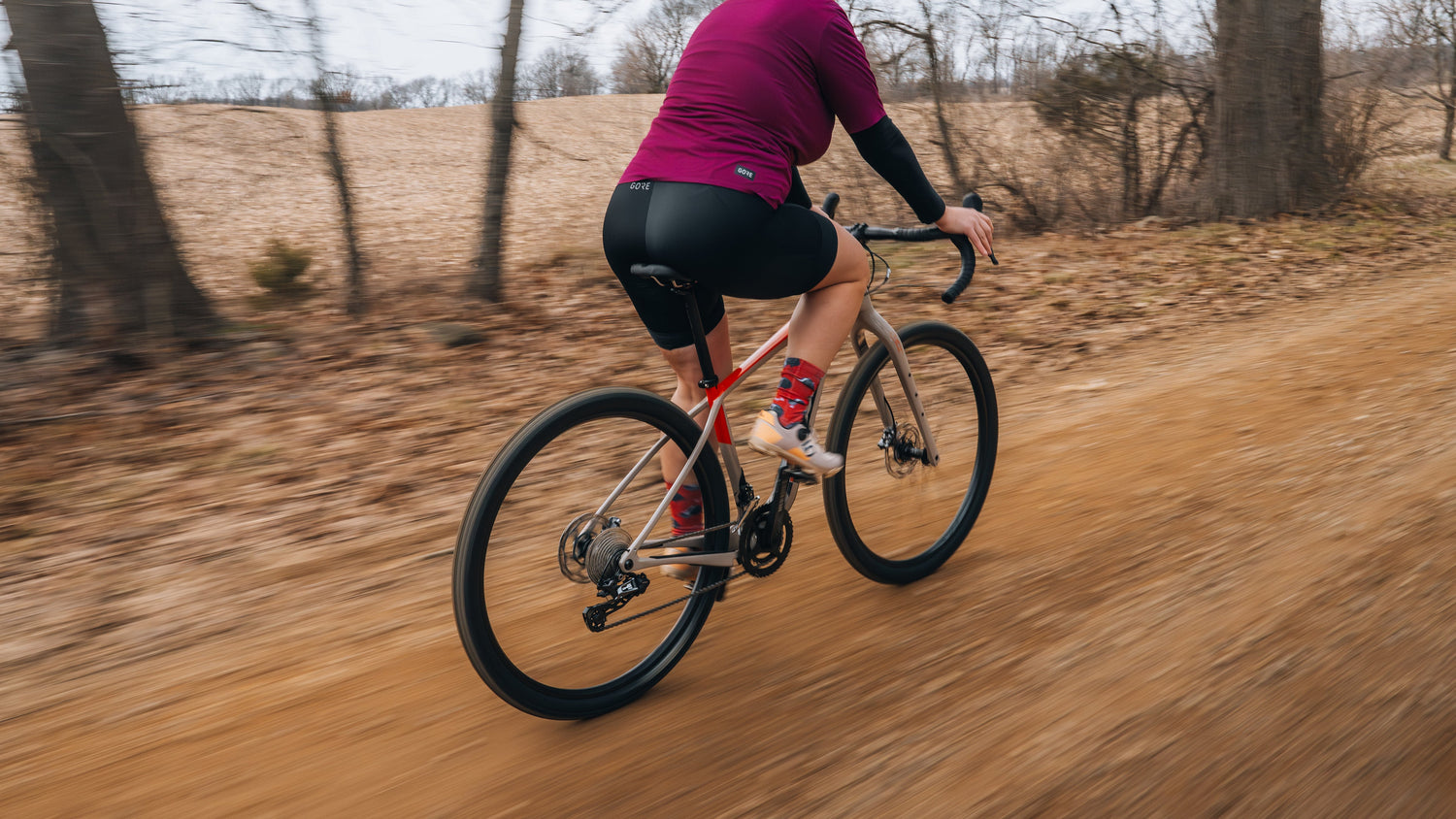 Cyclist rides a Salsa Cutthroat gravel bike on over dirt and gravel.