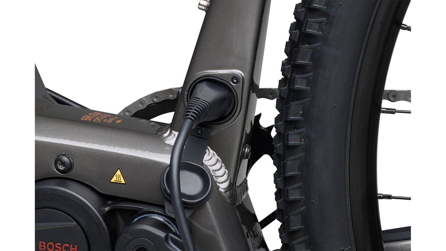 Salsa Tributary Ebike Apex Front Suspension in gray Bosch motor charging port plugged in on white background