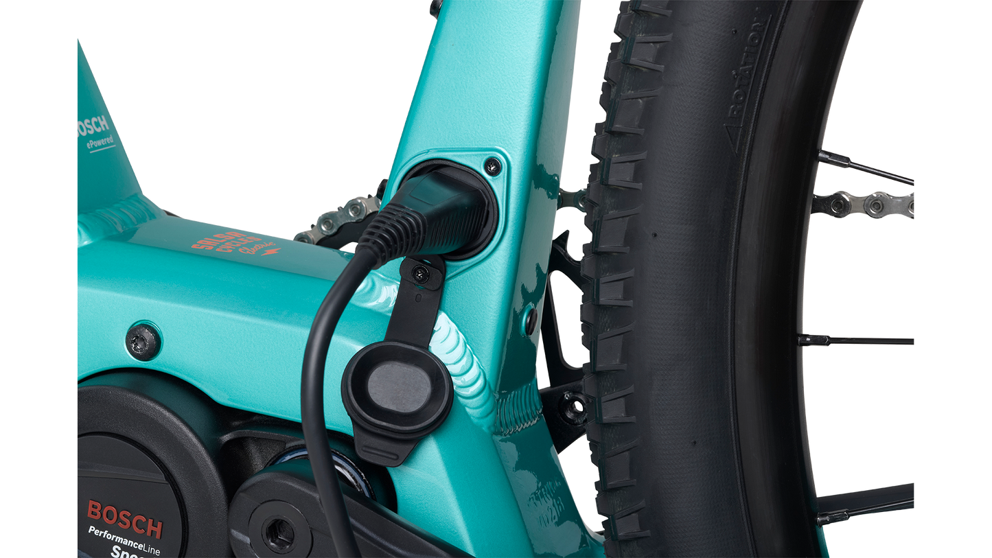 Salsa Tributary Ebike GRX 600 teal Bosch motor charging port plugged in on white background